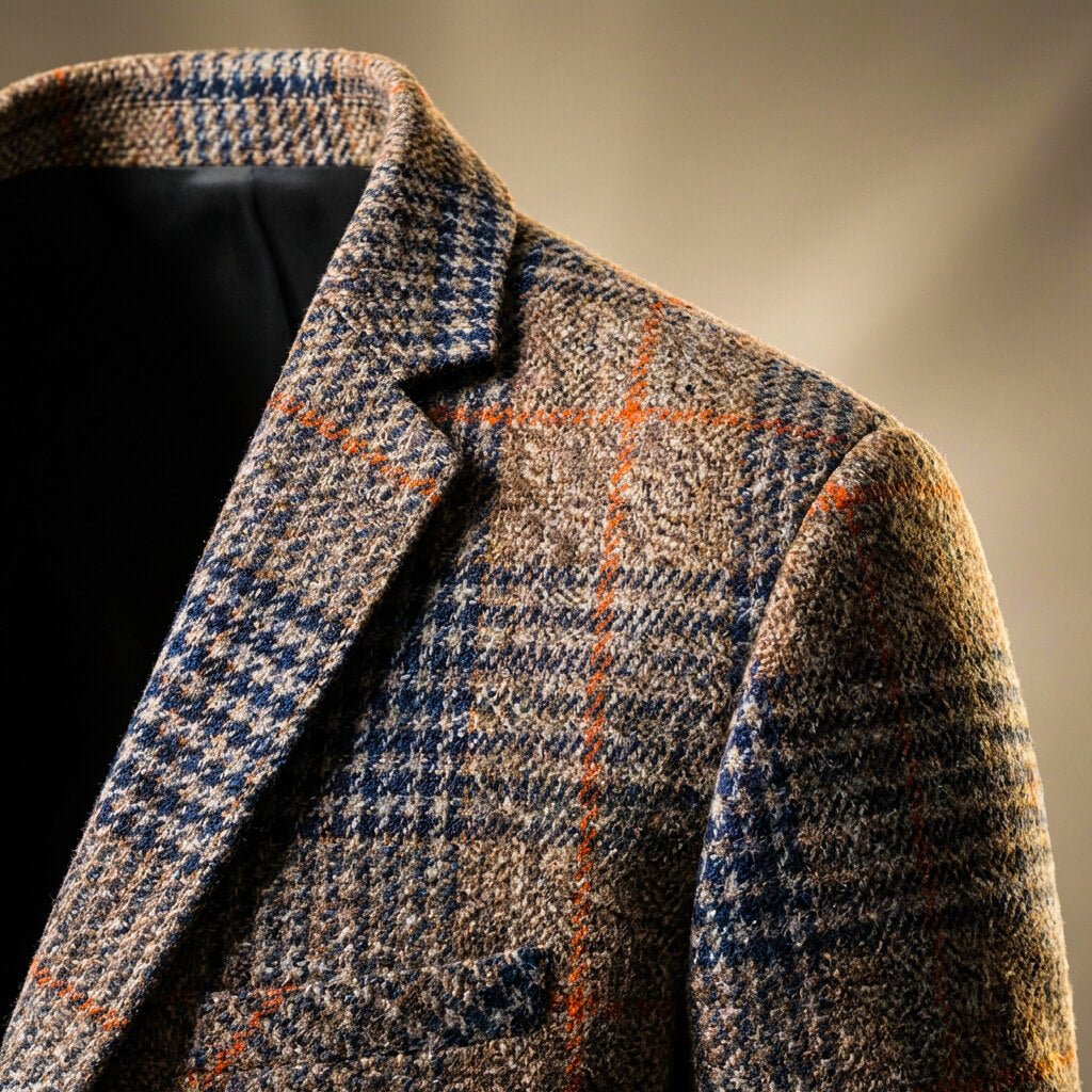 Close-up view of the notch lapel and check pattern on the brown blazer
