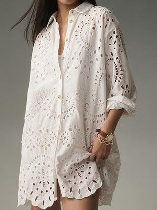 Front view of woman wearing white eyelet button-front tunic shirt