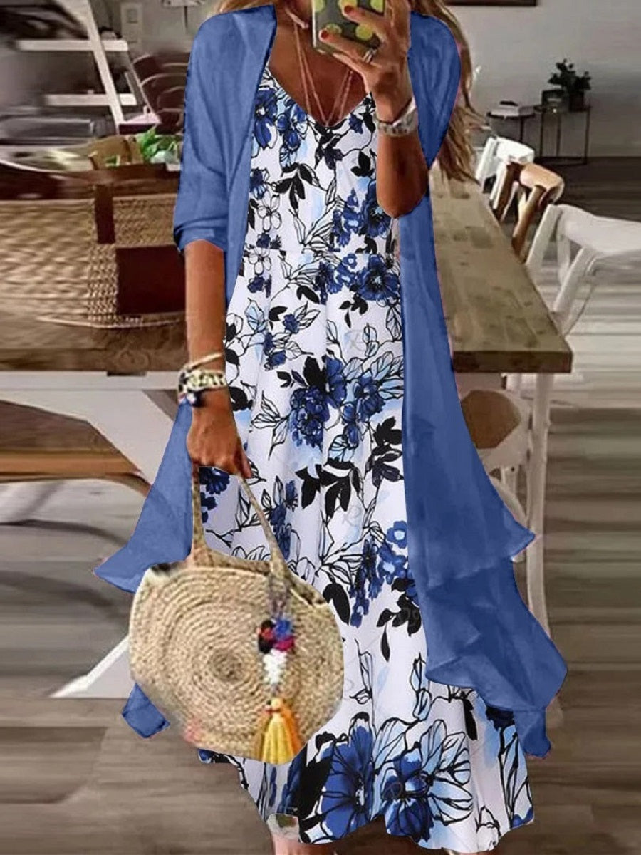 Woman wearing a blue floral maxi dress with matching sheer cardigan set