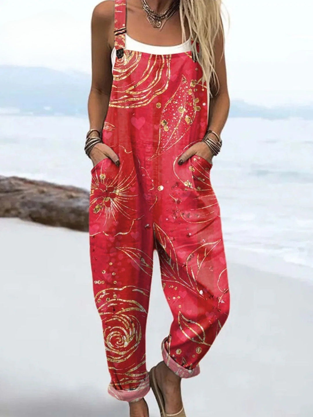 Woman wearing a pink wildflower printed casual jumpsuit near the beach