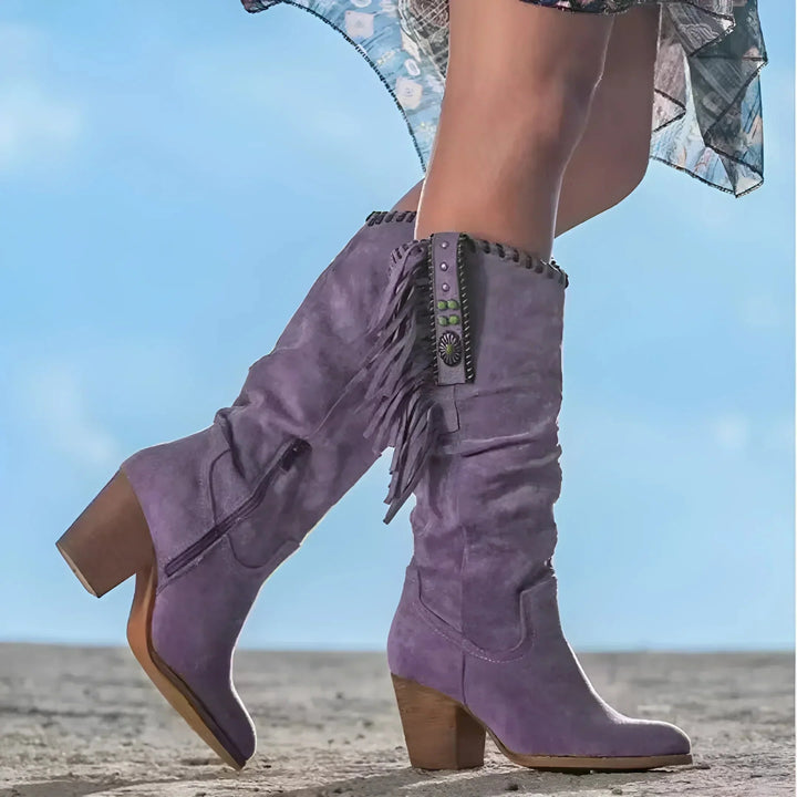 Side profile of women's leather cowboy boots featuring stylish fringe and western stitching