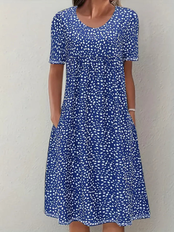 Woman wearing blue printed short sleeve midi dress with pockets