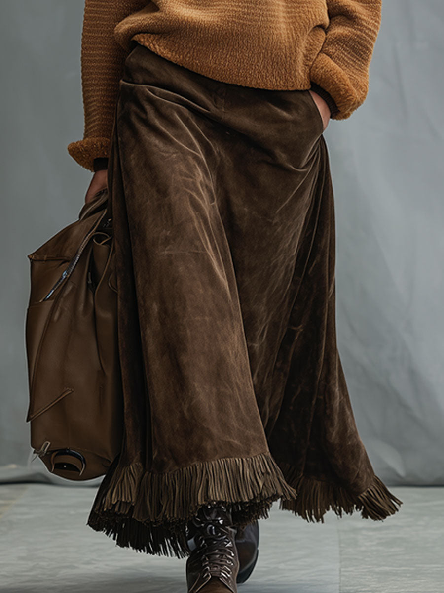 Model walking wearing the cocoa brown tassel midi skirt with a knitted sweater and boots