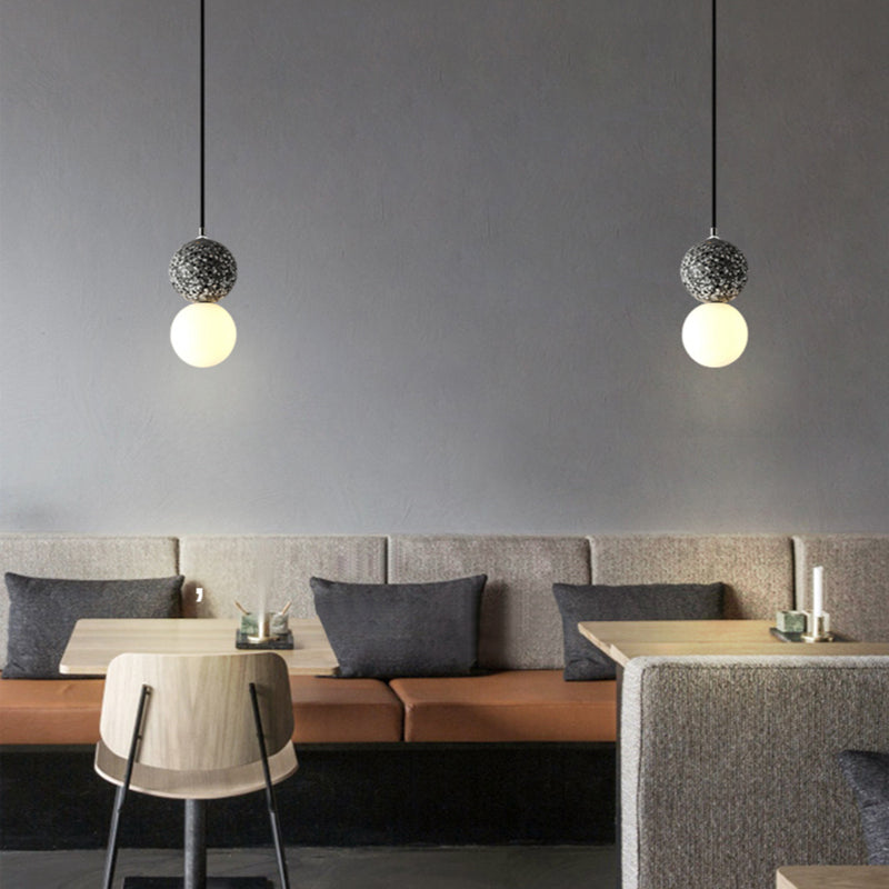 Modern hanglamp hanging at a low height to accent a small breakfast nook