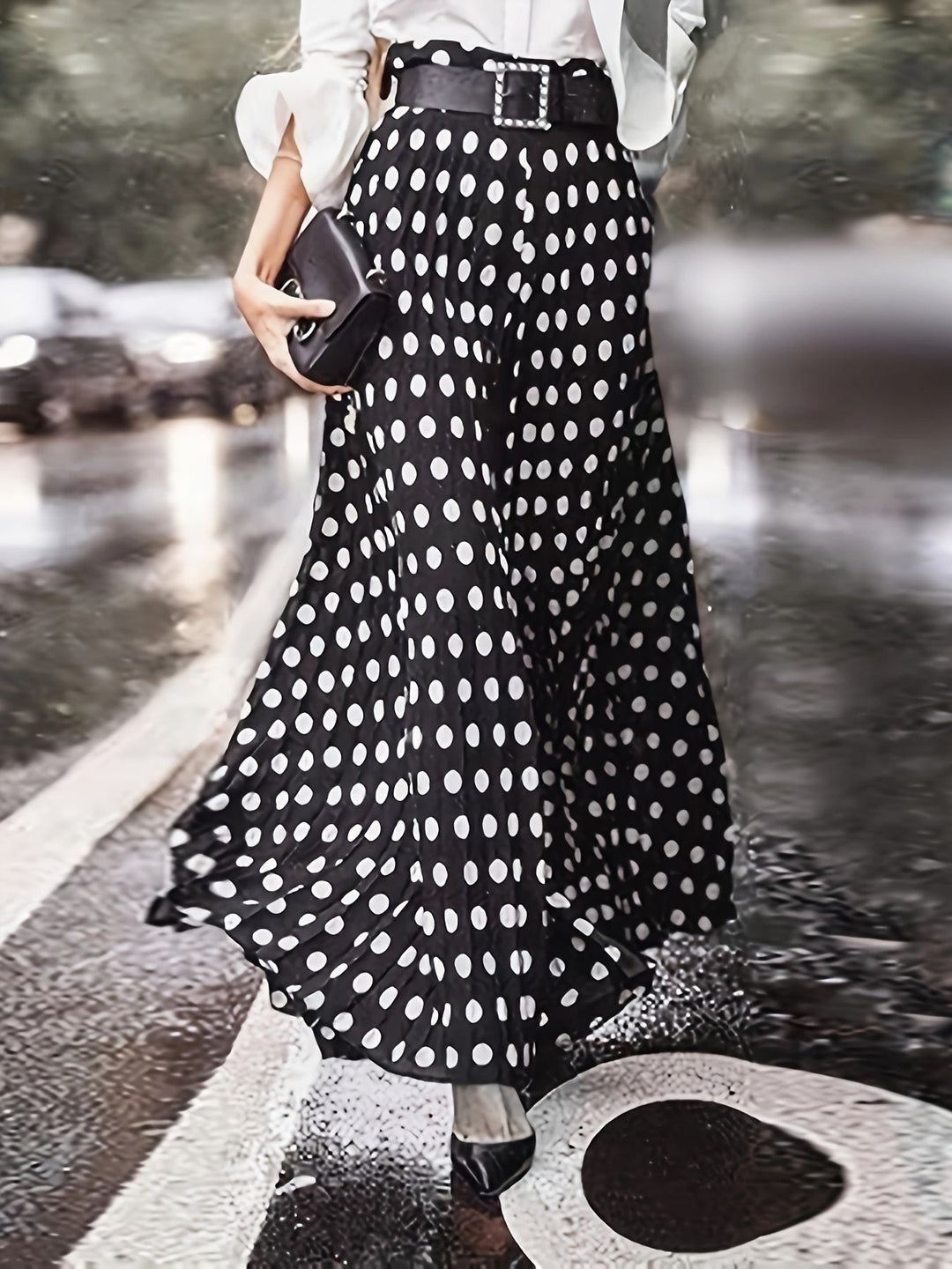 Close-up of plus size polka dot wide-leg trousers showcasing the flowing drape and patterned design