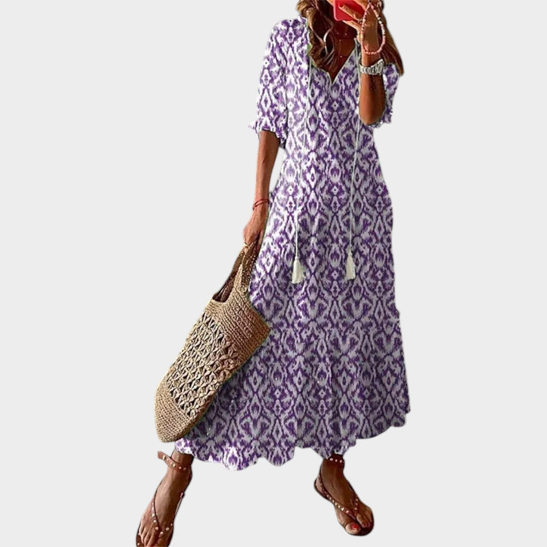 Woman wearing purple patterned boho maxi dress with short sleeves
