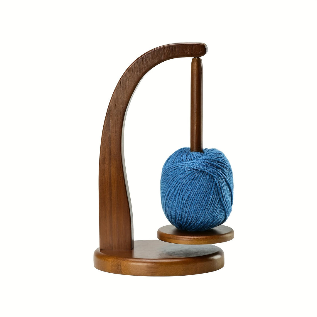 Wooden yarn holder holding a blue yarn ball