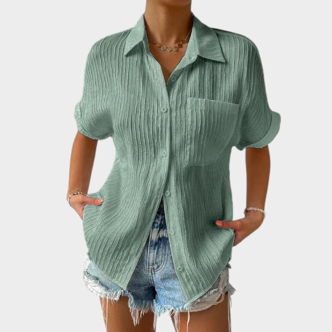 Close-up view of textured fabric on a women's short sleeve blouse