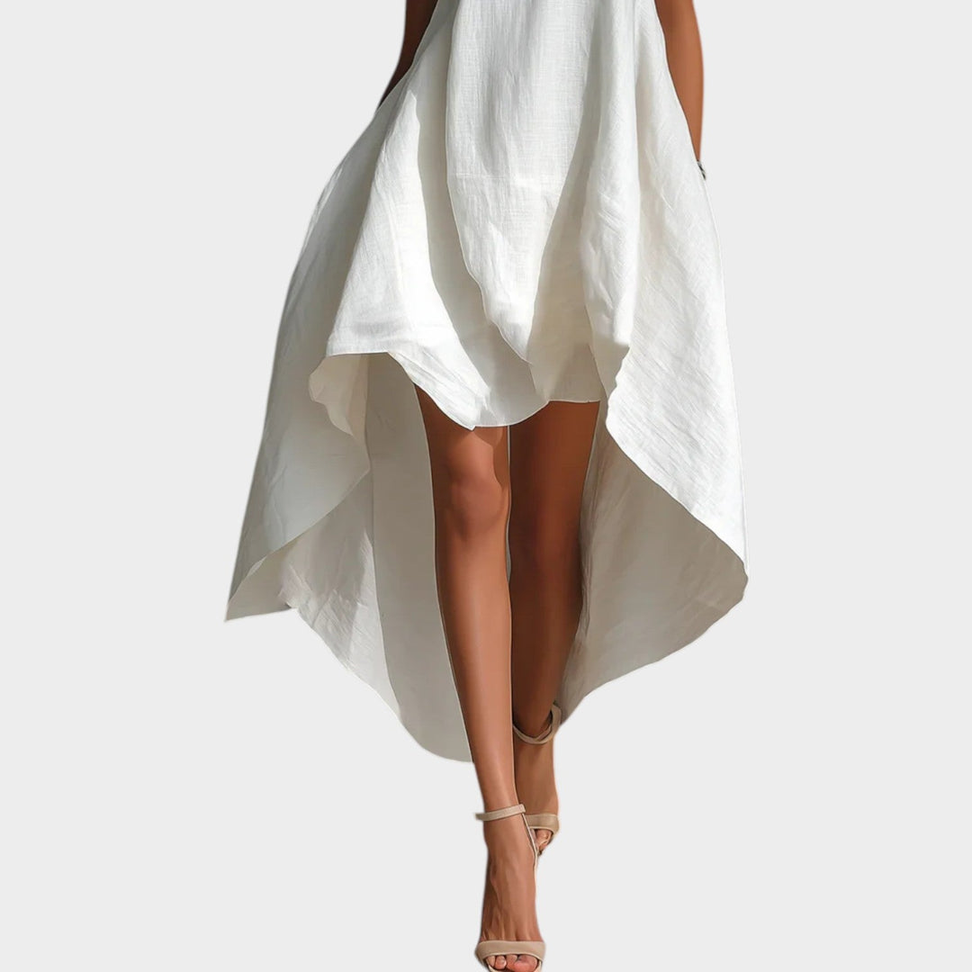 Close-up view of the high-low asymmetrical hemline on a white midi dress