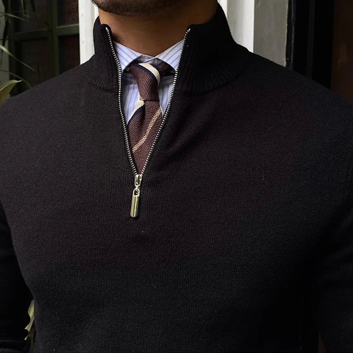 Close-up view of the mock neck and silver zipper on the black men's sweater