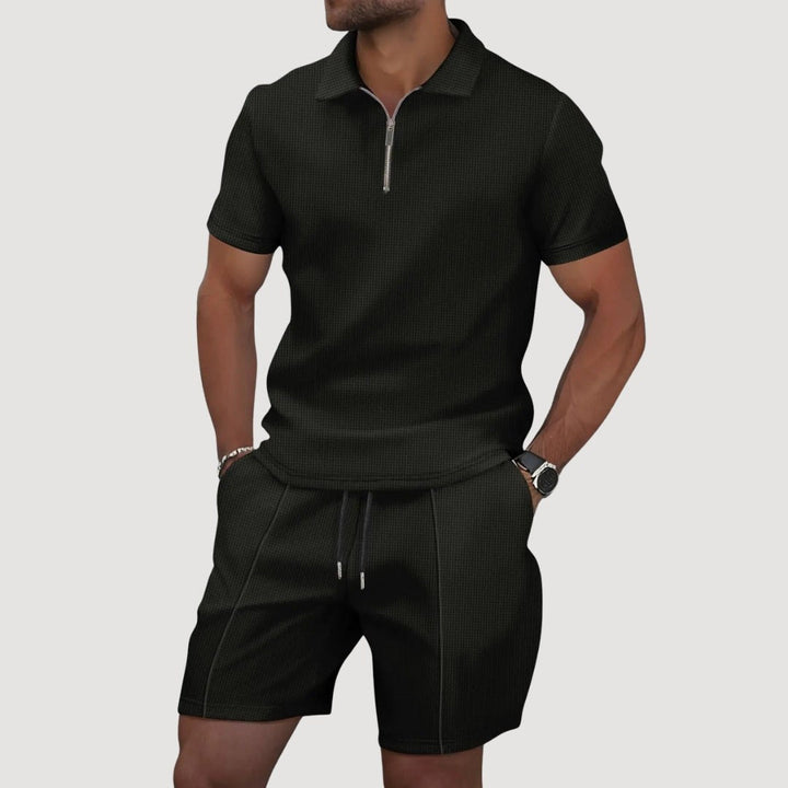 Man wearing black textured polo and shorts two-piece set