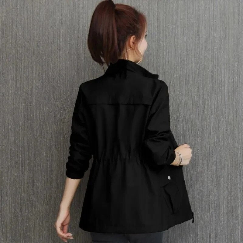 Back view of a woman wearing a black utility jacket with cinched waist