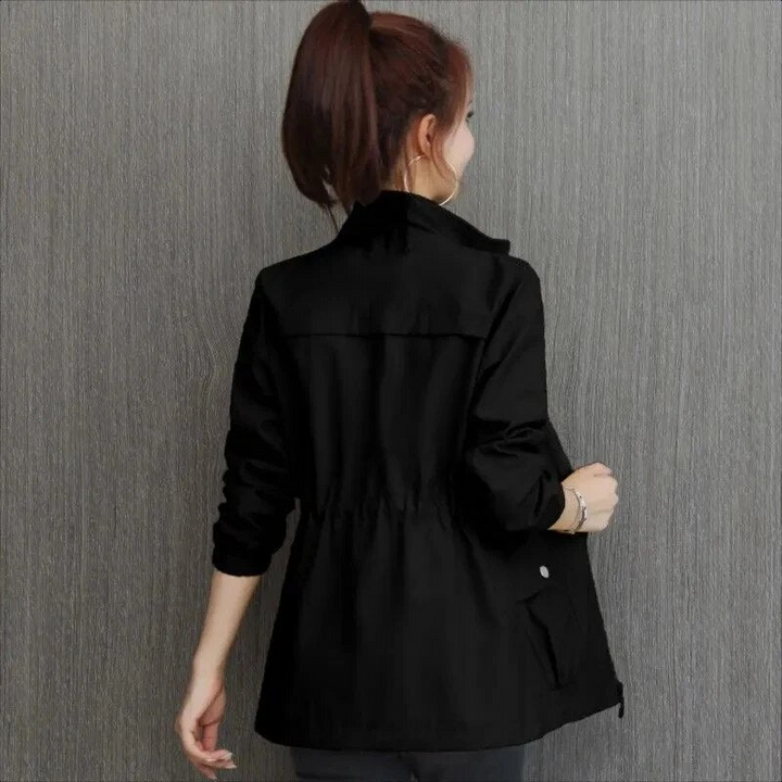 Back view of a woman wearing a black utility jacket with cinched waist