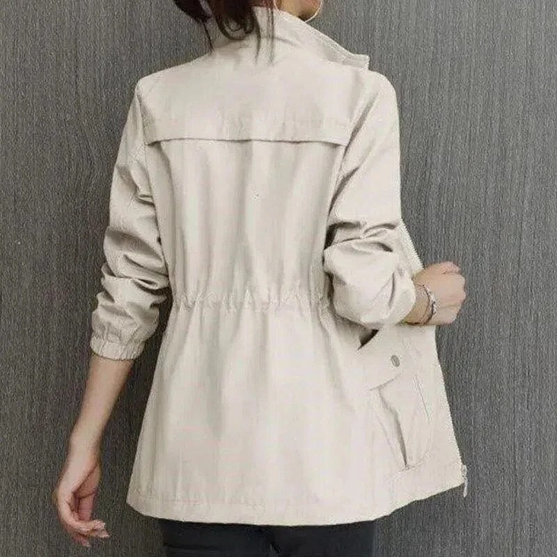 Back view of a woman wearing a beige utility jacket with stand collar