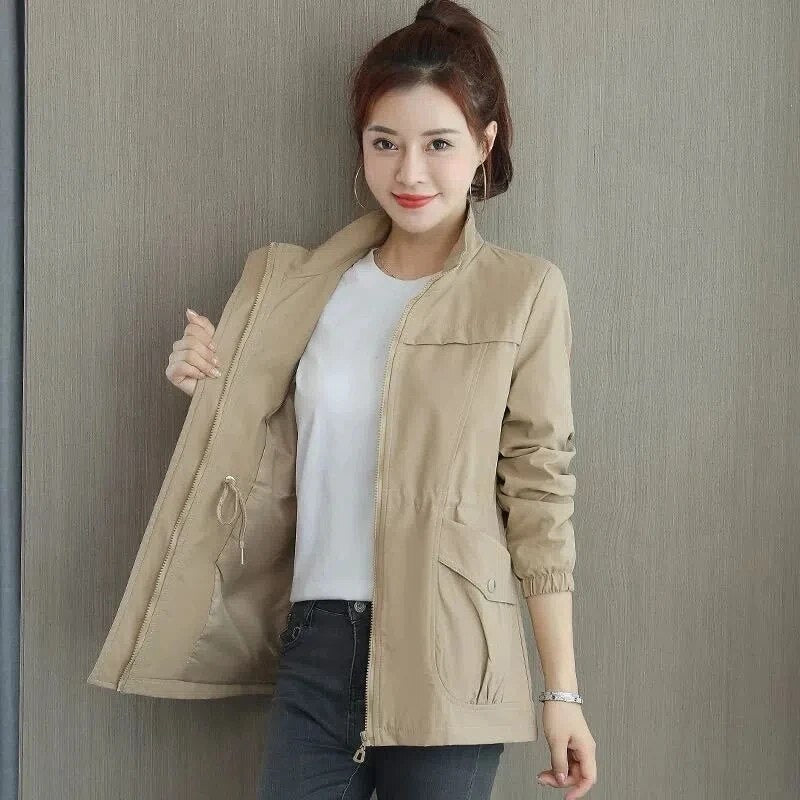 Woman wearing a khaki utility drawstring jacket with full zip and pockets