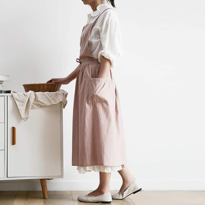 Pink waterproof kitchen apron with large front pockets for cooking and baking