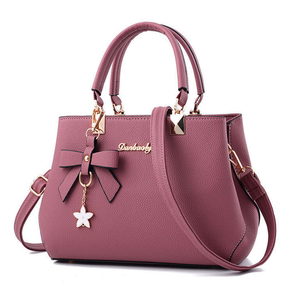 Dark pink women's Anna crossbody bag with bow charm displayed on a white background