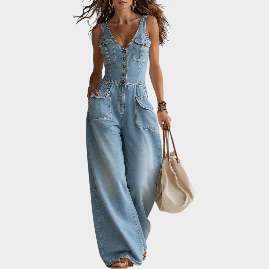 Model wearing light blue denim wide leg button-up jumpsuit outdoors