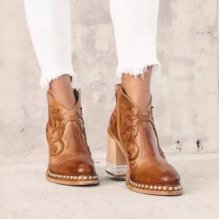 Side profile of womens fashion cowboy boots featuring ankle cut-outs and block heel