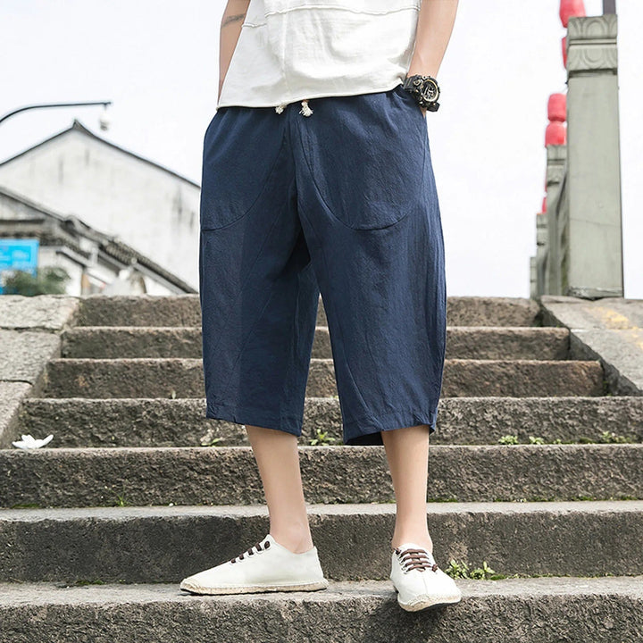 Man wearing navy blue casual three-quarter trousers outdoors