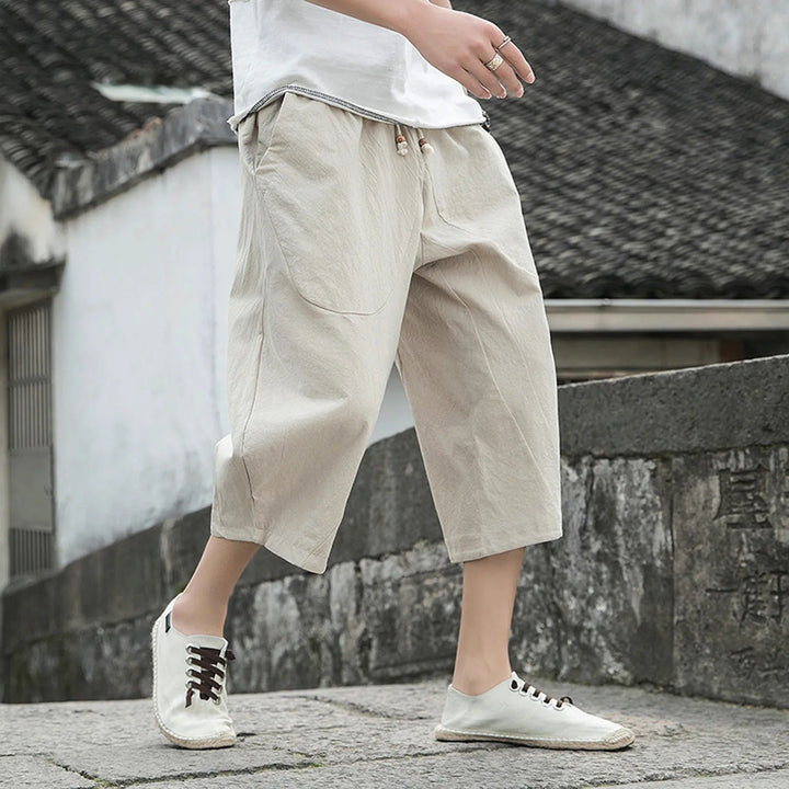 Man wearing beige casual three-quarter trousers on stone steps
