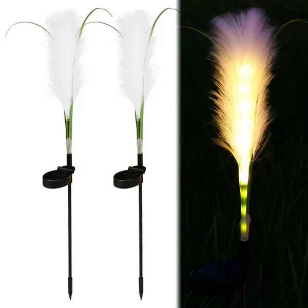 Solar powered outdoor reed lamp accentuating pathway landscape design