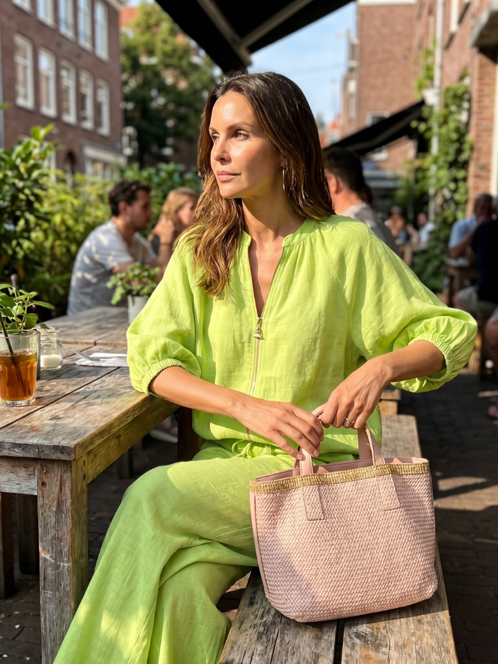 Close-up of the zip-front blouson top from the chic two-piece outfit