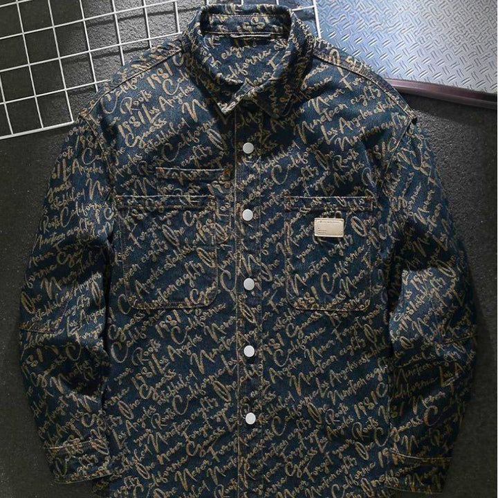 Close-up view of the detailed script embroidery on the men's denim jacket