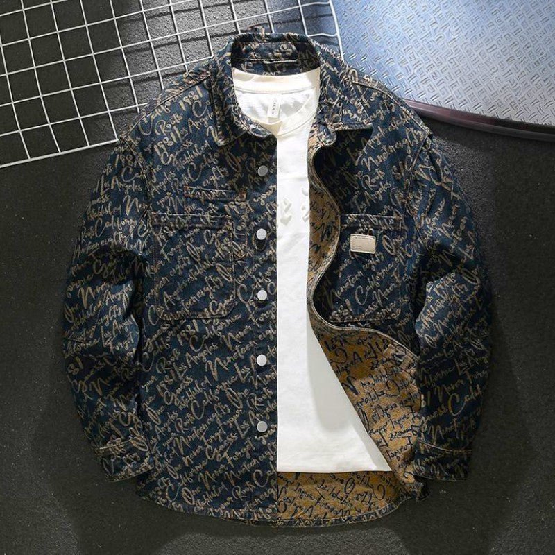 Men's embroidered script denim jacket laid flat on a dark surface