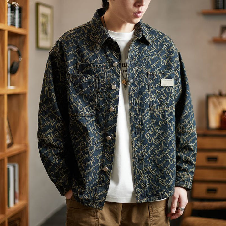 Man wearing the embroidered script denim jacket in a stylish indoor setting