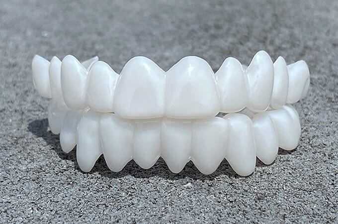 Customizable dental prosthesis lenses displayed on a textured surface