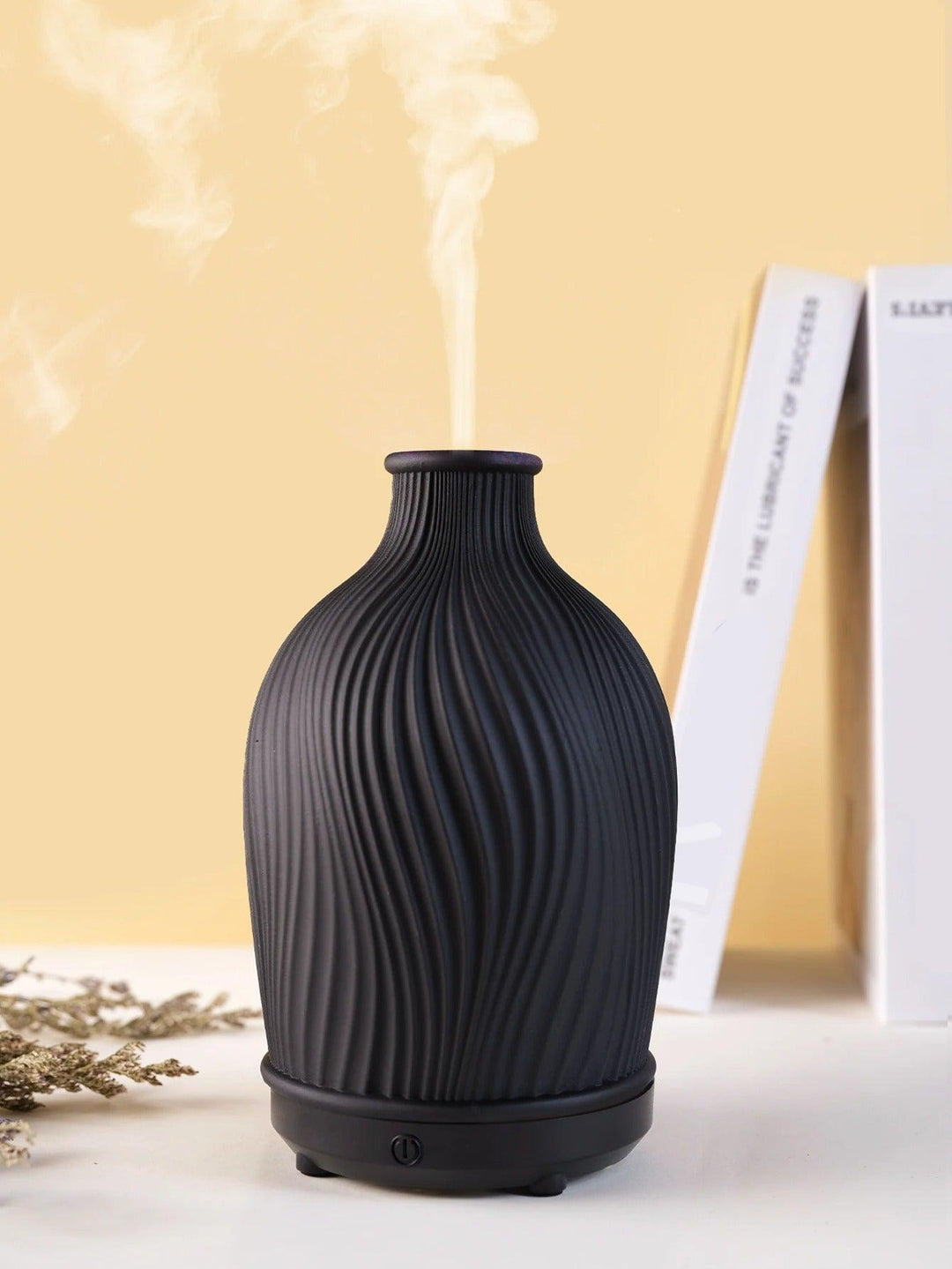 BohoMist essential oil diffuser styled on a bohemian shelf with candles.
