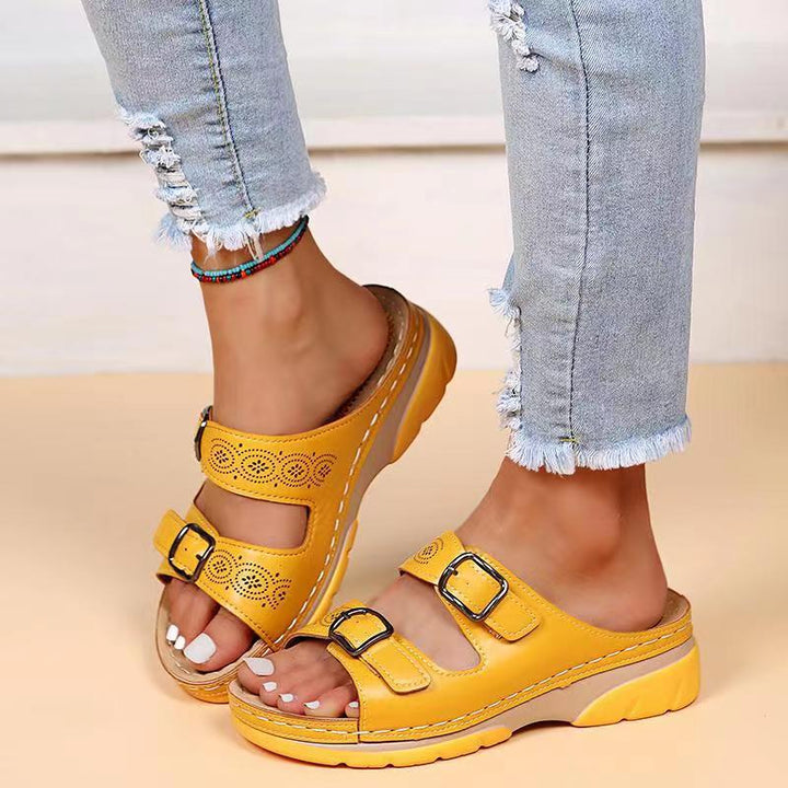 Casual footwear slide sandals featuring dual strap buckles, top view