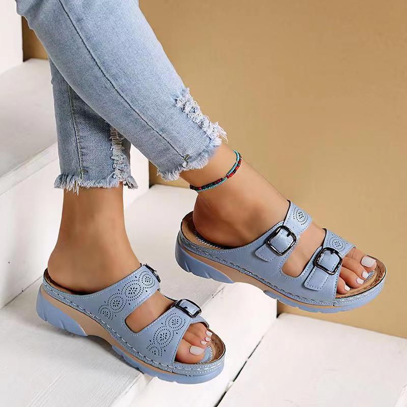 Women's light blue double buckle comfort slide sandals worn with jeans