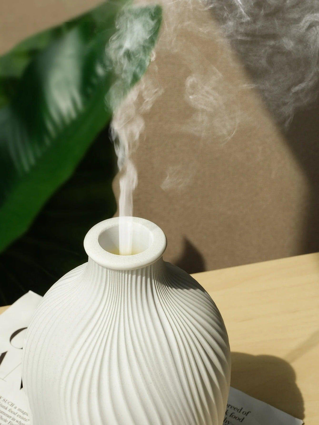 Close-up of BohoMist aroma diffuser top opening with mist