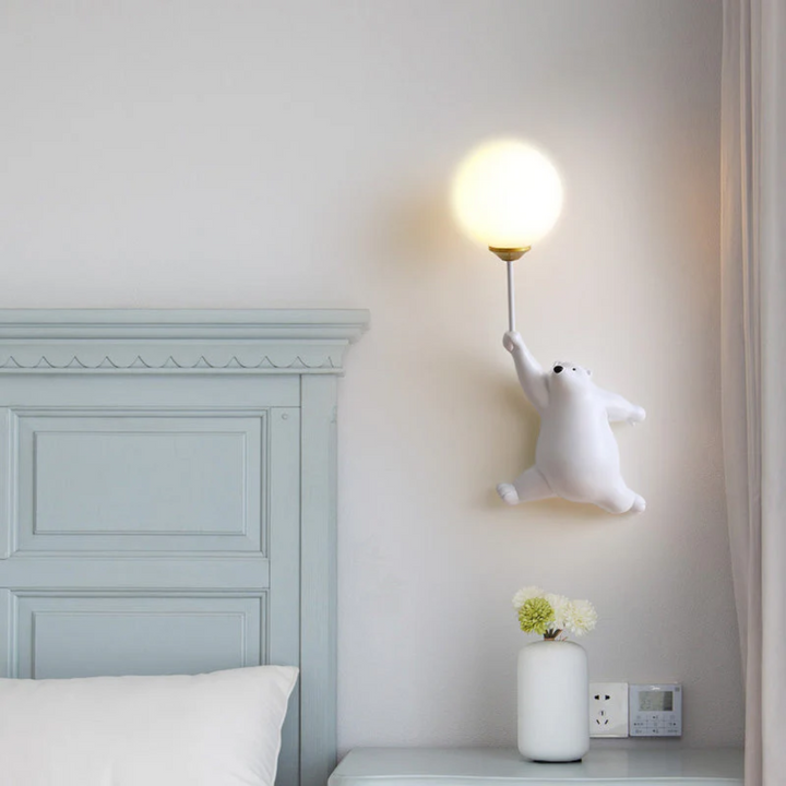 Detail shot of the bear LED wall lamp fixture hardware and warm light glow