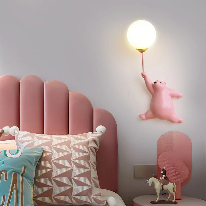 Illuminated bear night light mounted on a pastel colored child bedroom wall