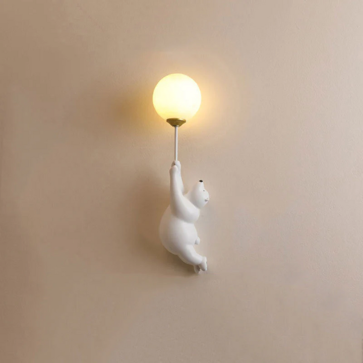 Full view of the white bear wall lamp mounted on a neutral wall
