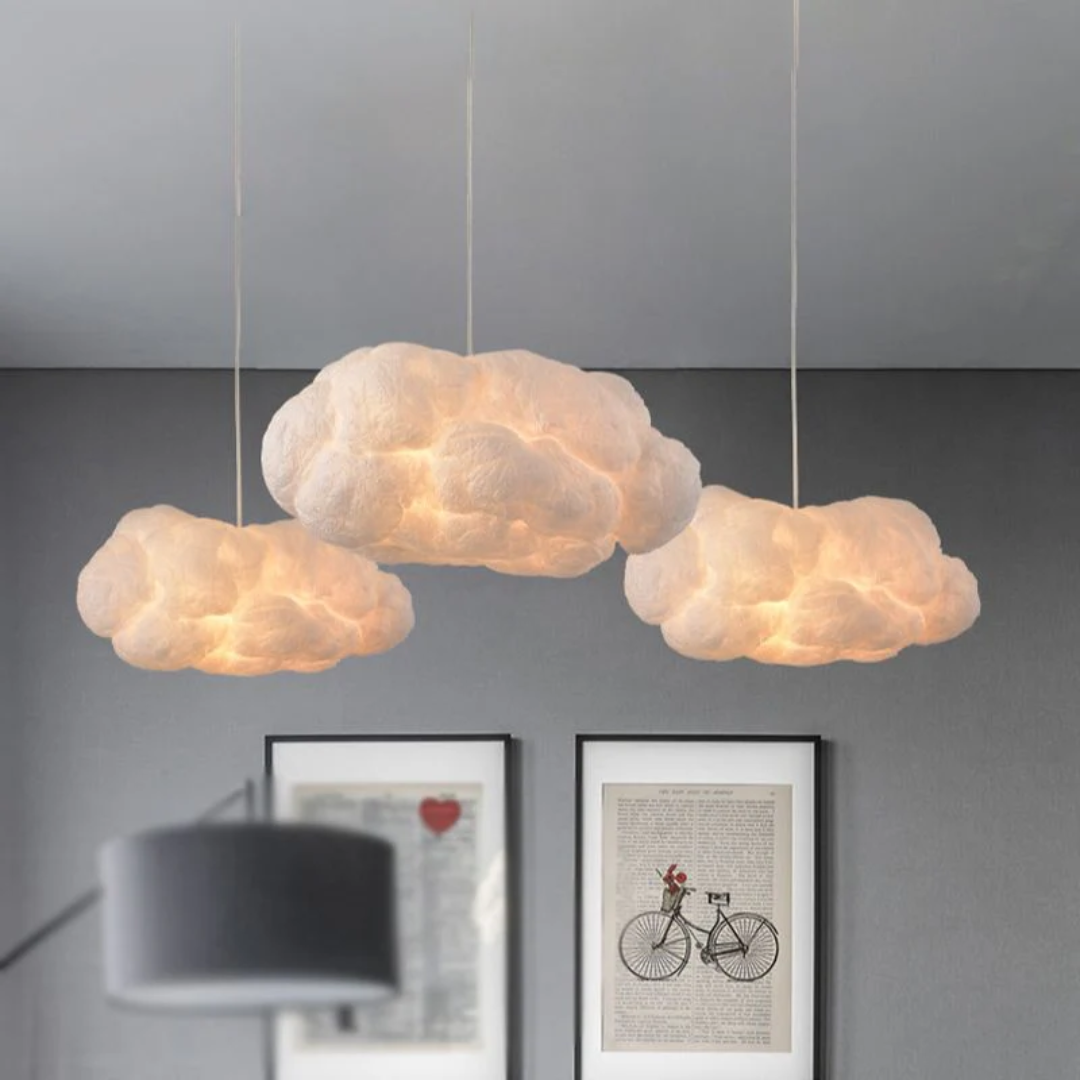 Three Nimbus Cloud LED Pendant Lights hanging at different heights over a grey wall