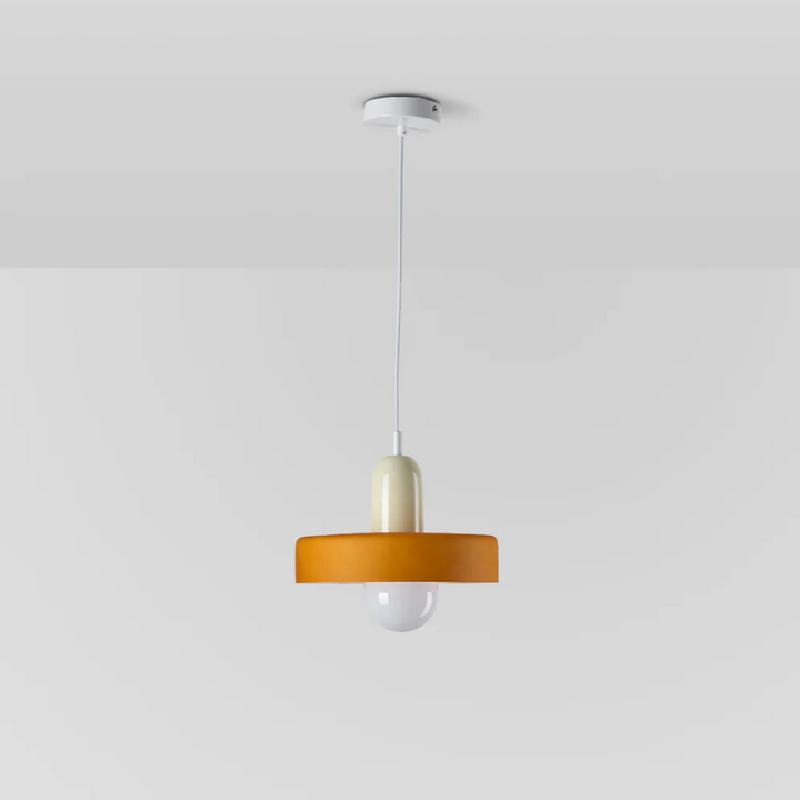 Side view of the designer glass pendant light illuminated in a neutral room