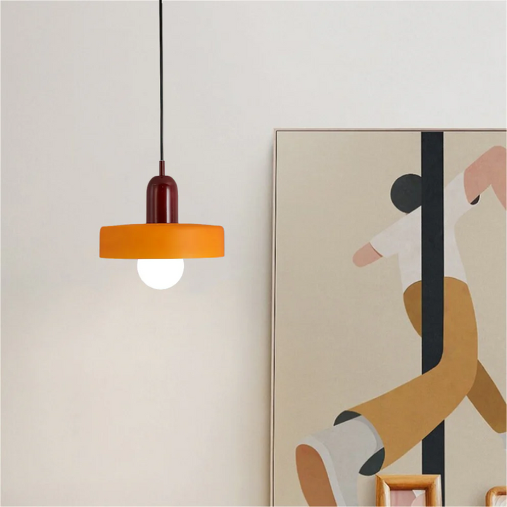Designer home decor lighting piece suspended over a coffee table