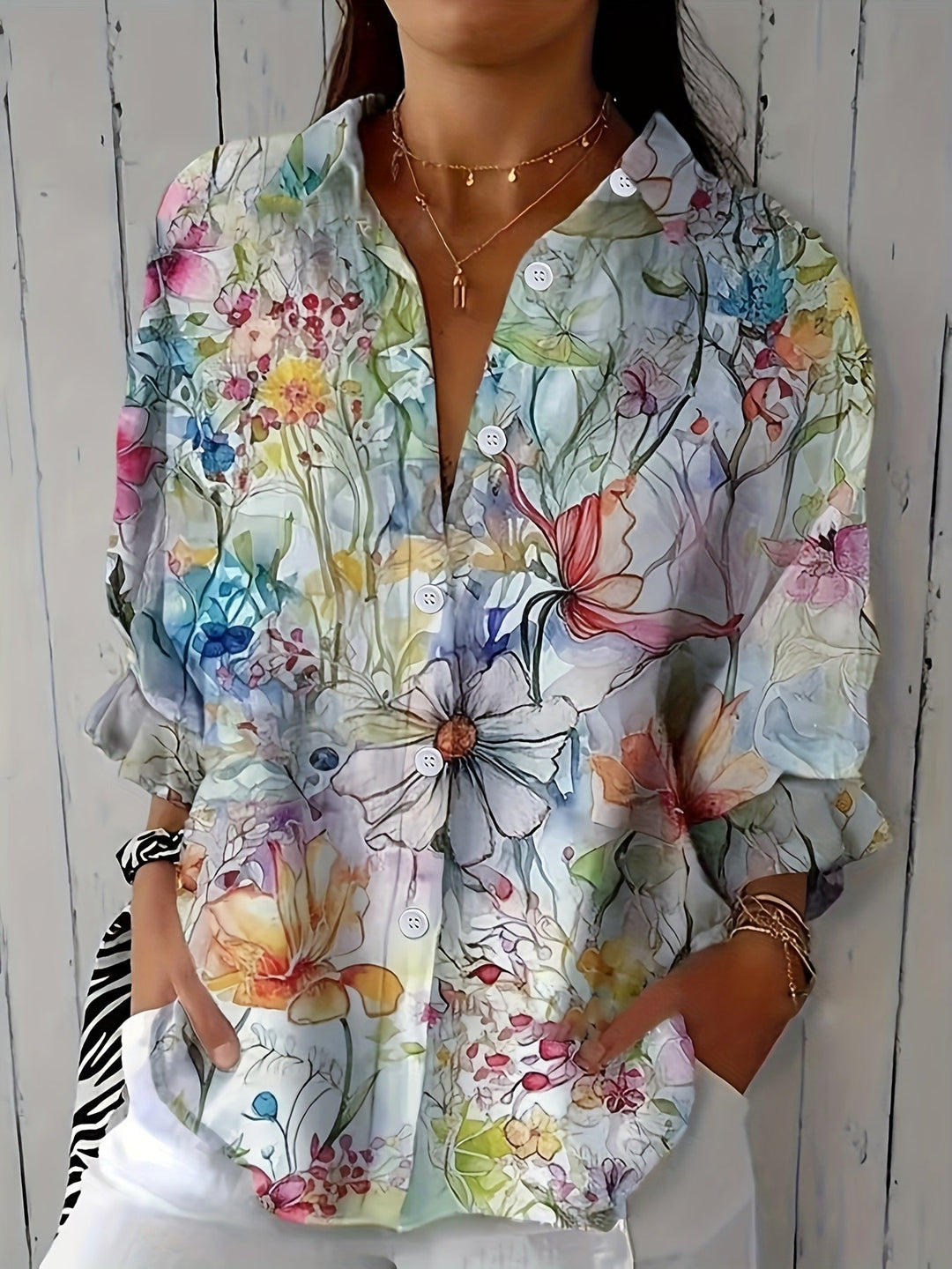 Woman wearing a retro floral button-front blouse in a casual setting