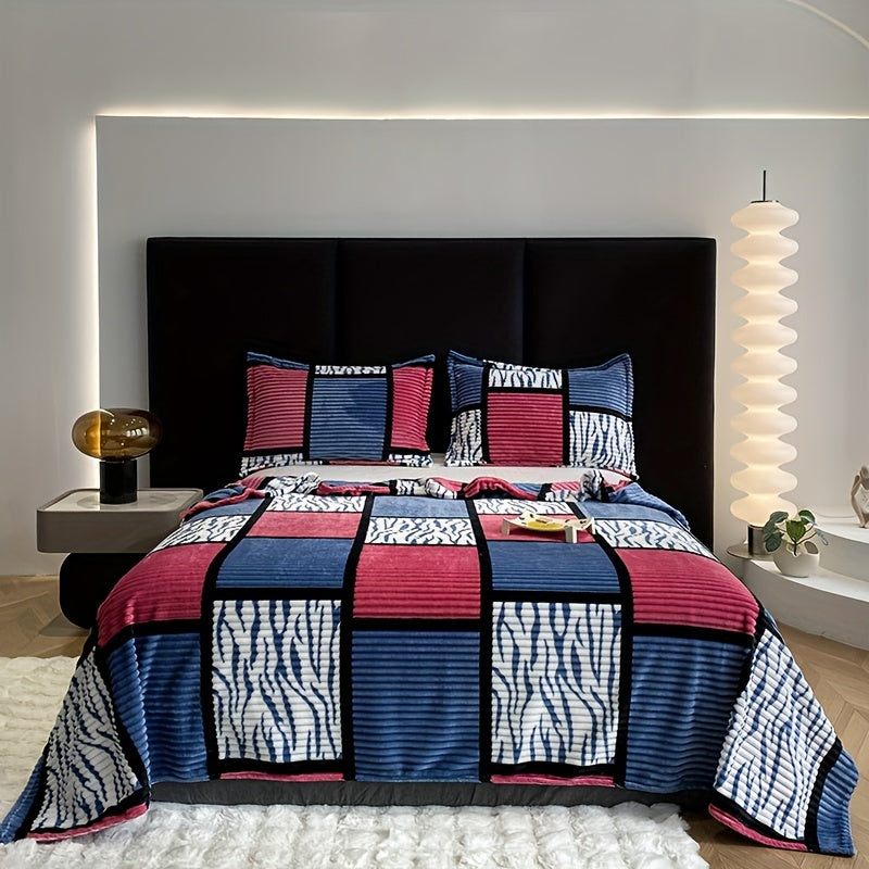 Blue and pink geometric grid pattern flannel blanket on a bed
