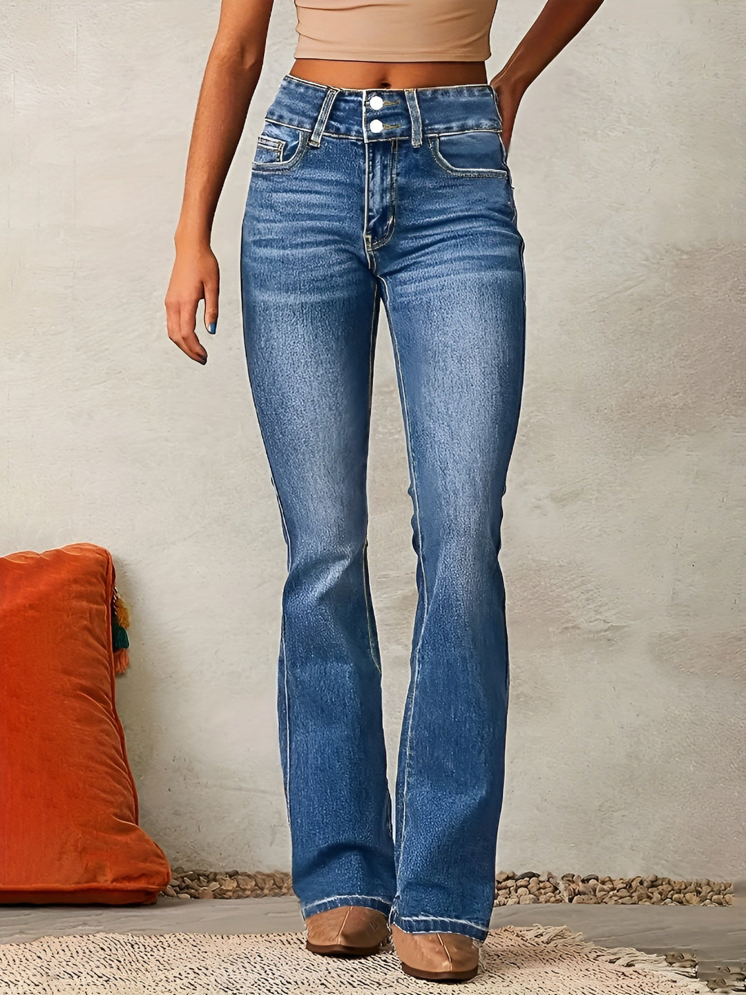 Woman wearing light blue flared jeans with high waist