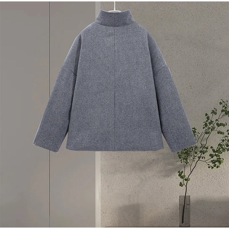 Close-up of high neck collar on black womens winter jacket