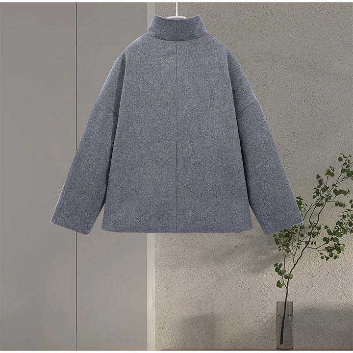 Close-up of high neck collar on black womens winter jacket