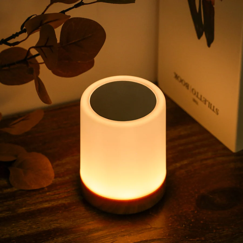 Close-up of the warm glowing night light on a wooden surface