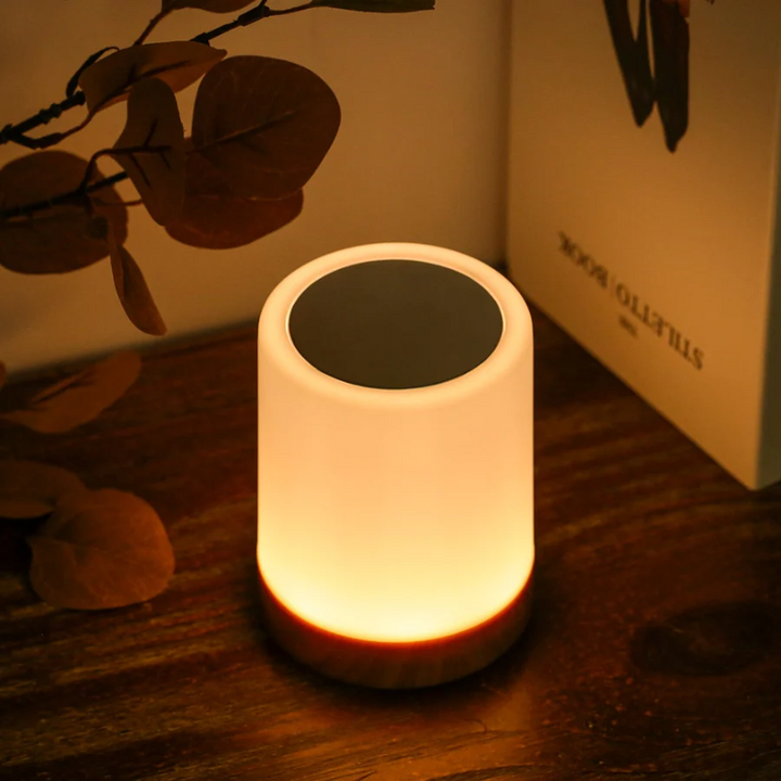 Close-up of the warm glowing night light on a wooden surface