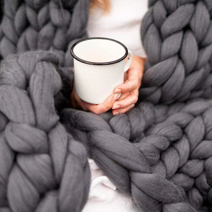 Chunky yarn ball in a cozy living room setting for DIY blankets