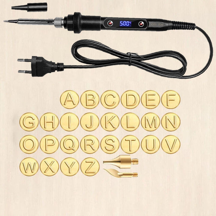 DIY wood burning tool with 26 brass letter tips laid out flat